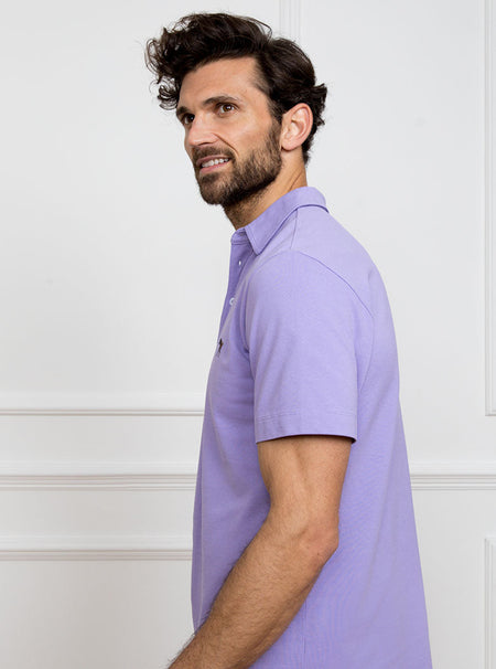 Man wearing lilac polo shirt in 100% cotton with Newmarket 875 horse logo embroidered on the front.